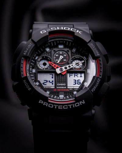 Матово-черные противоударные часы G-SHOCK GA-100-1A4ER дополнены красными акцентами на черном циферблате.
